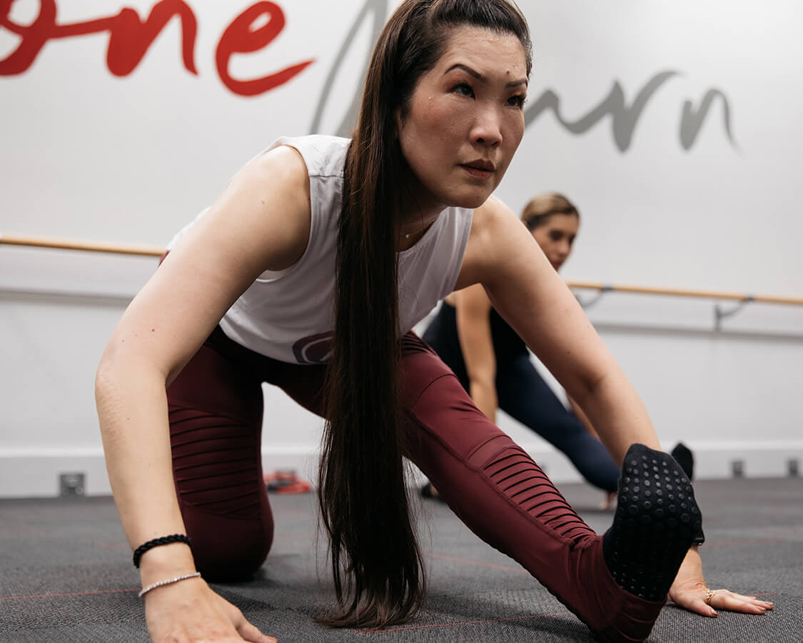 Two people stretching at Pure Barre
